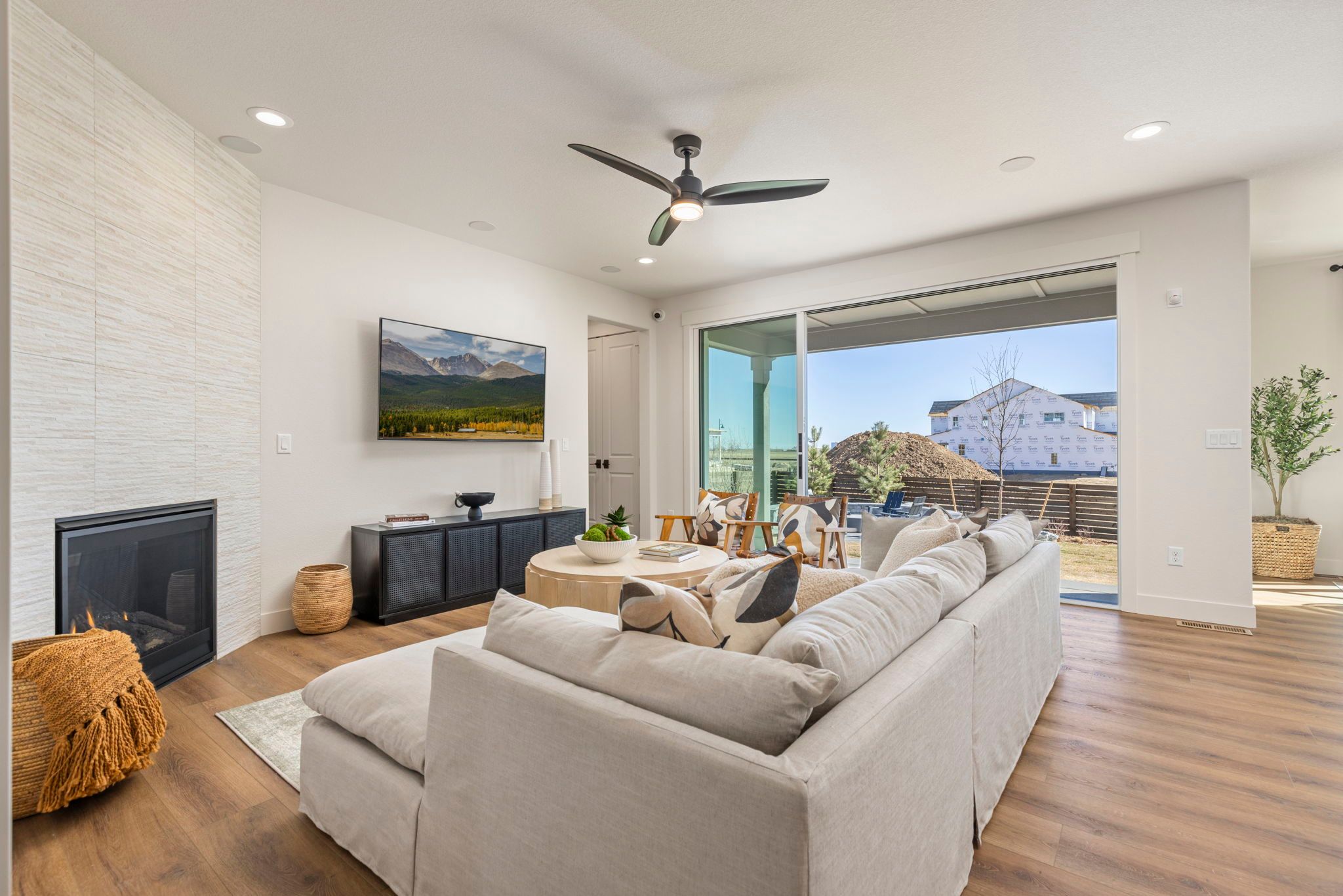 Open Living Room with Fireplace and Sliding Glass Doors | Barefoot Lakes Firestone CO