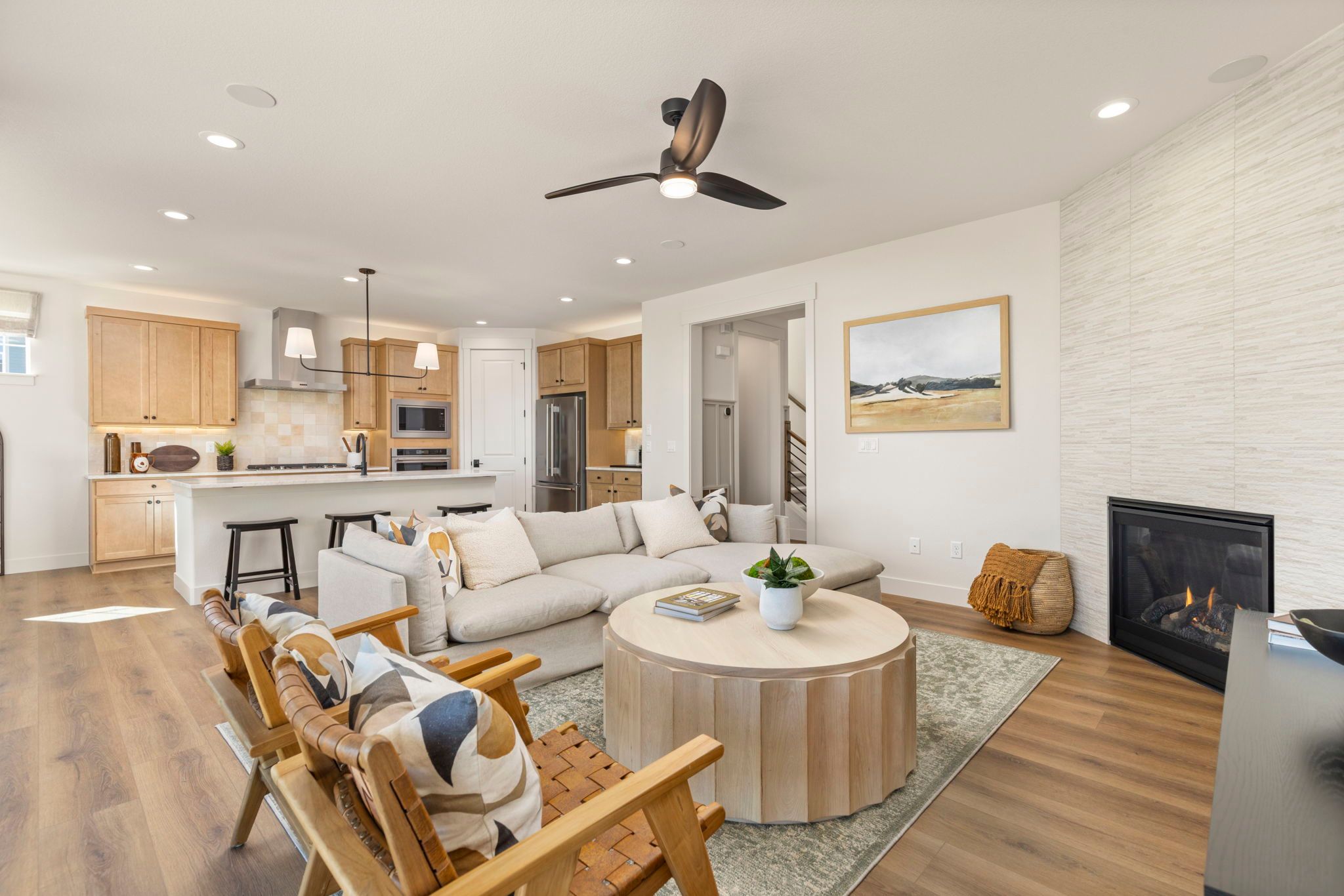 Open Concept Living Area with Fireplace and Kitchen View | Barefoot Lakes Firestone CO