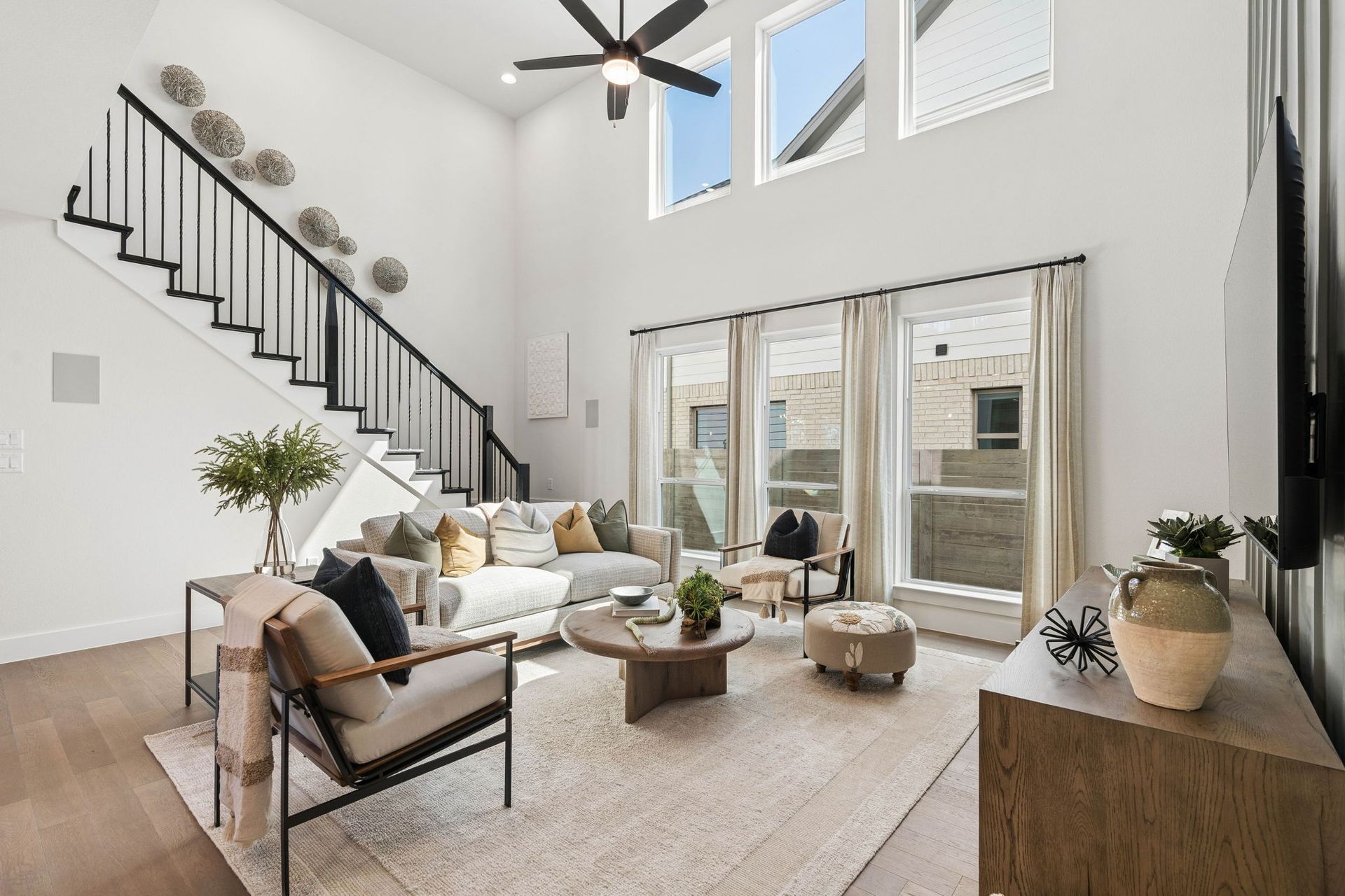 Open Living Room with Modern Staircase - Representative Photo of Plan 1462