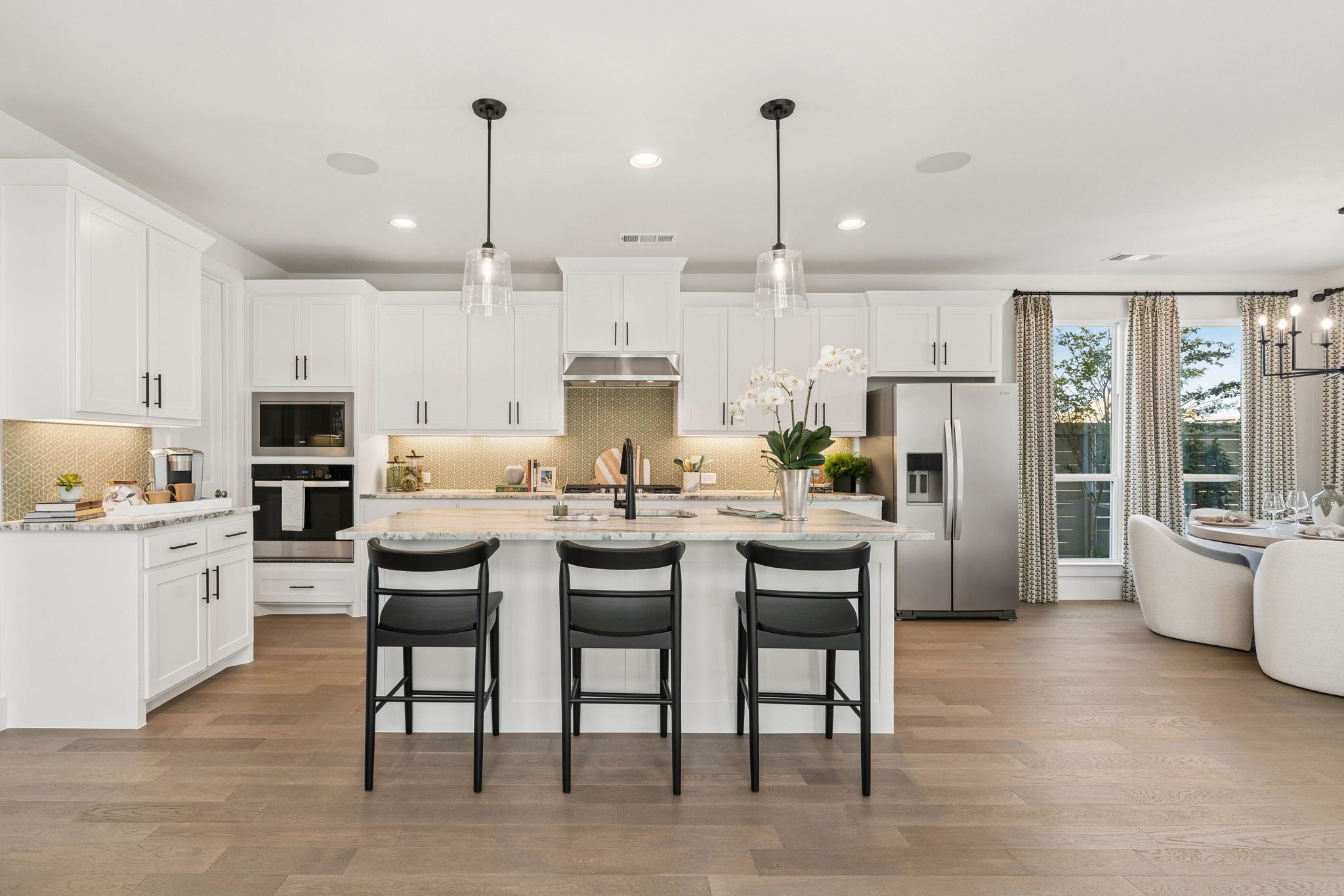 Gourmet Kitchen with White Cabinetry in American Legend Homes Model - Representative Photo of Plan