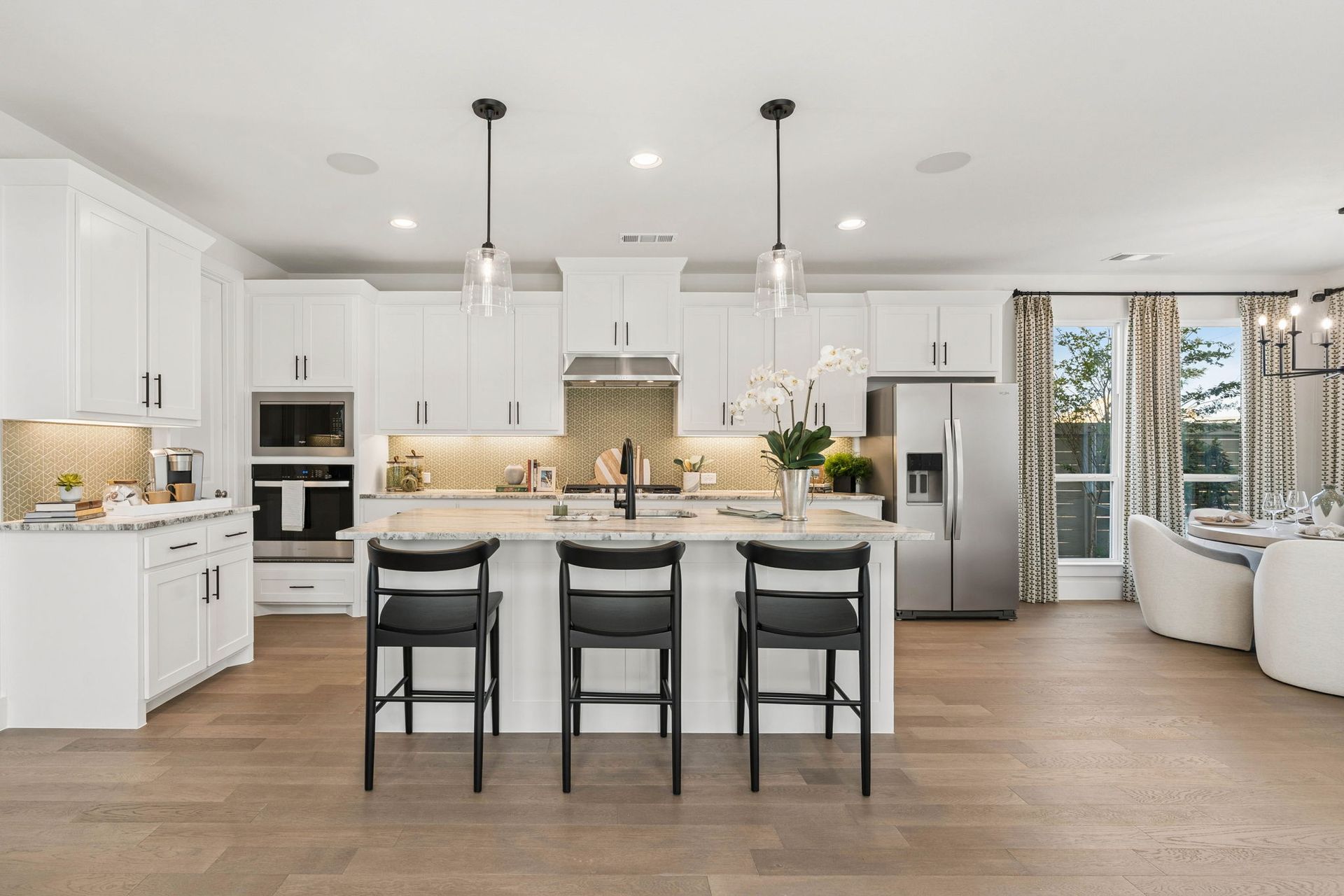 Gourmet Kitchen with White Cabinetry in American Legend Homes Model - Representative Photo of Plan