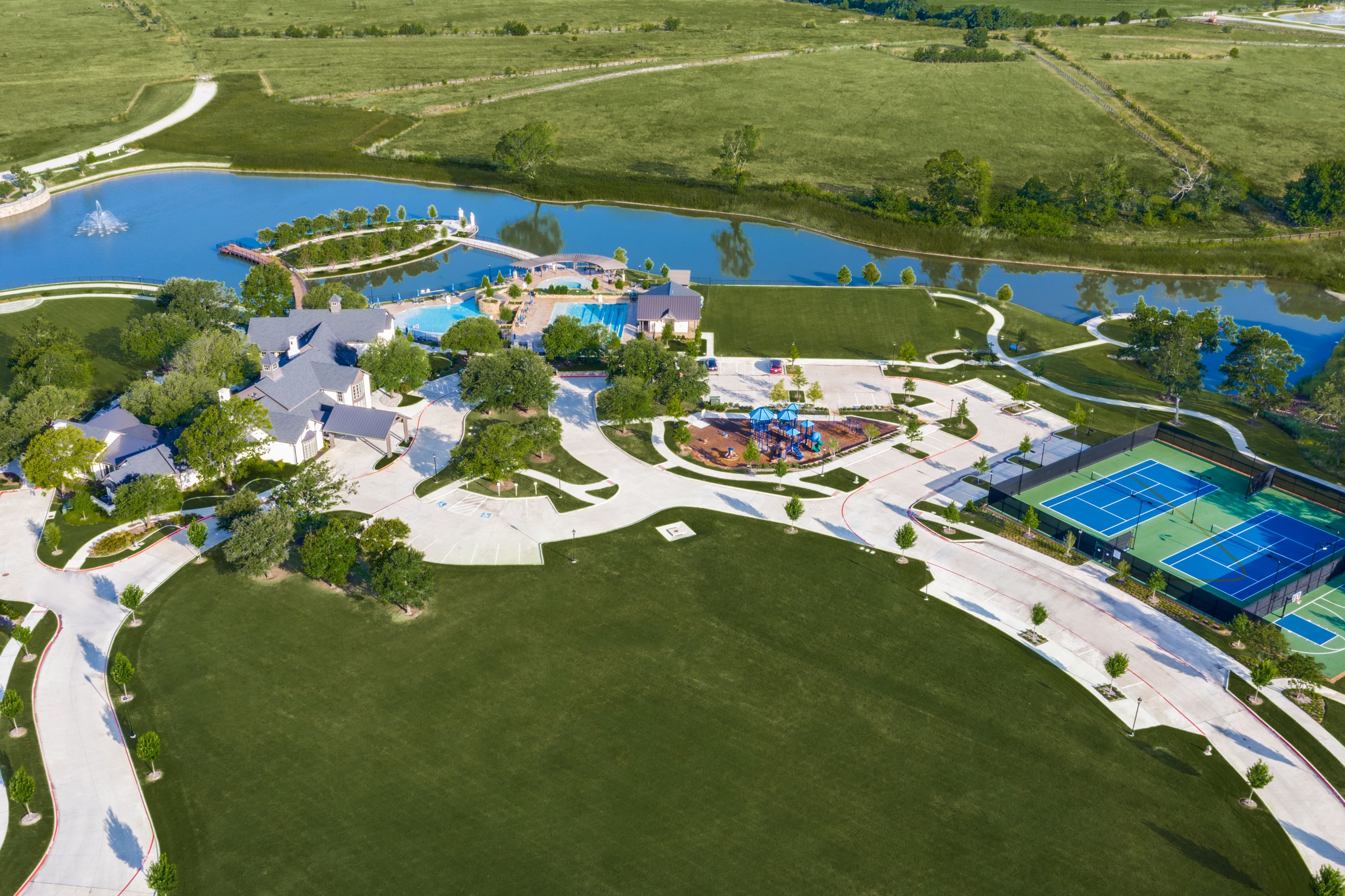 Mustang Lakes - Aerial of pond/pool/tennis court/playground area