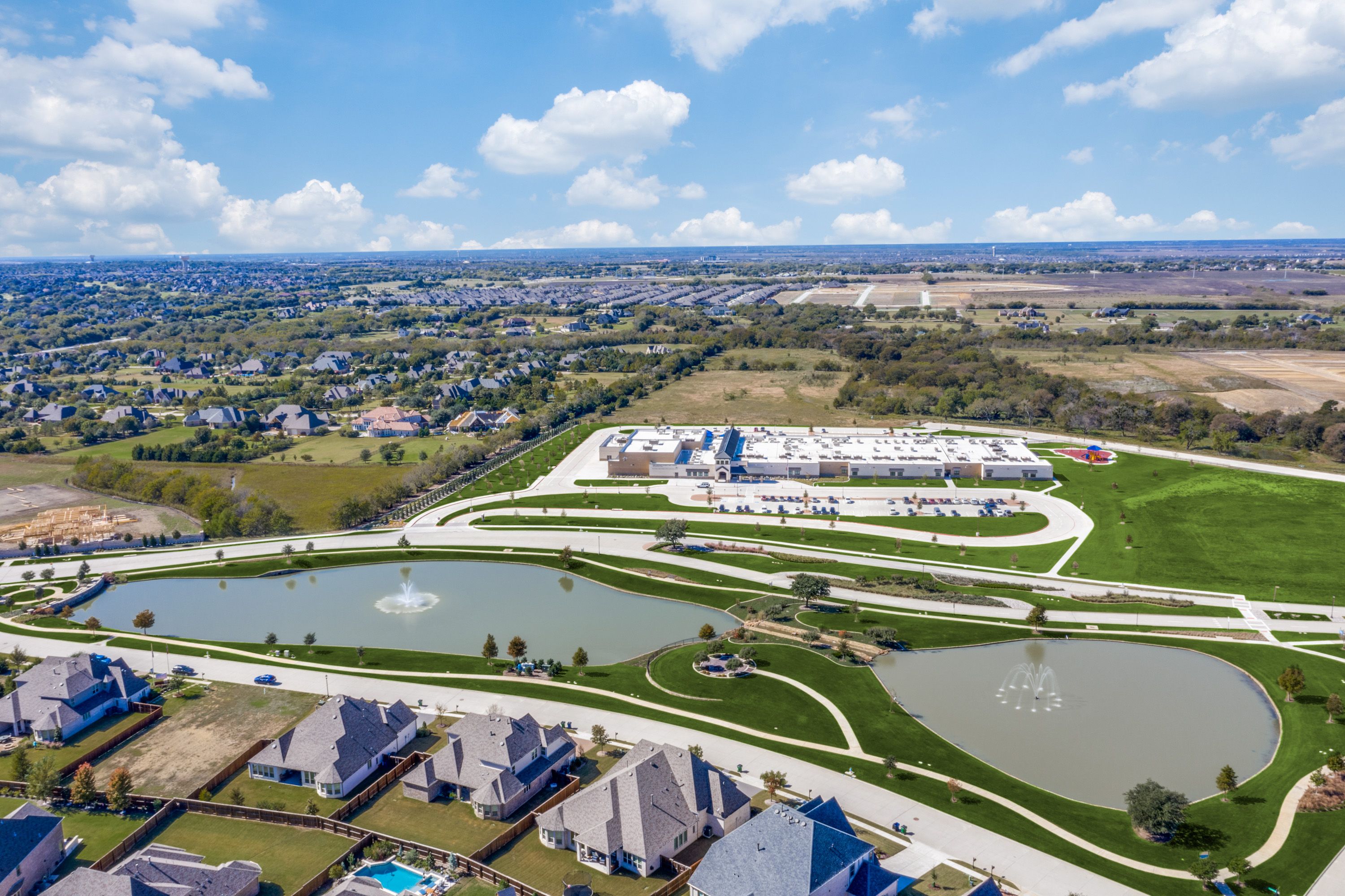 Mustang Lakes - Aerial of pond/school/streetscape