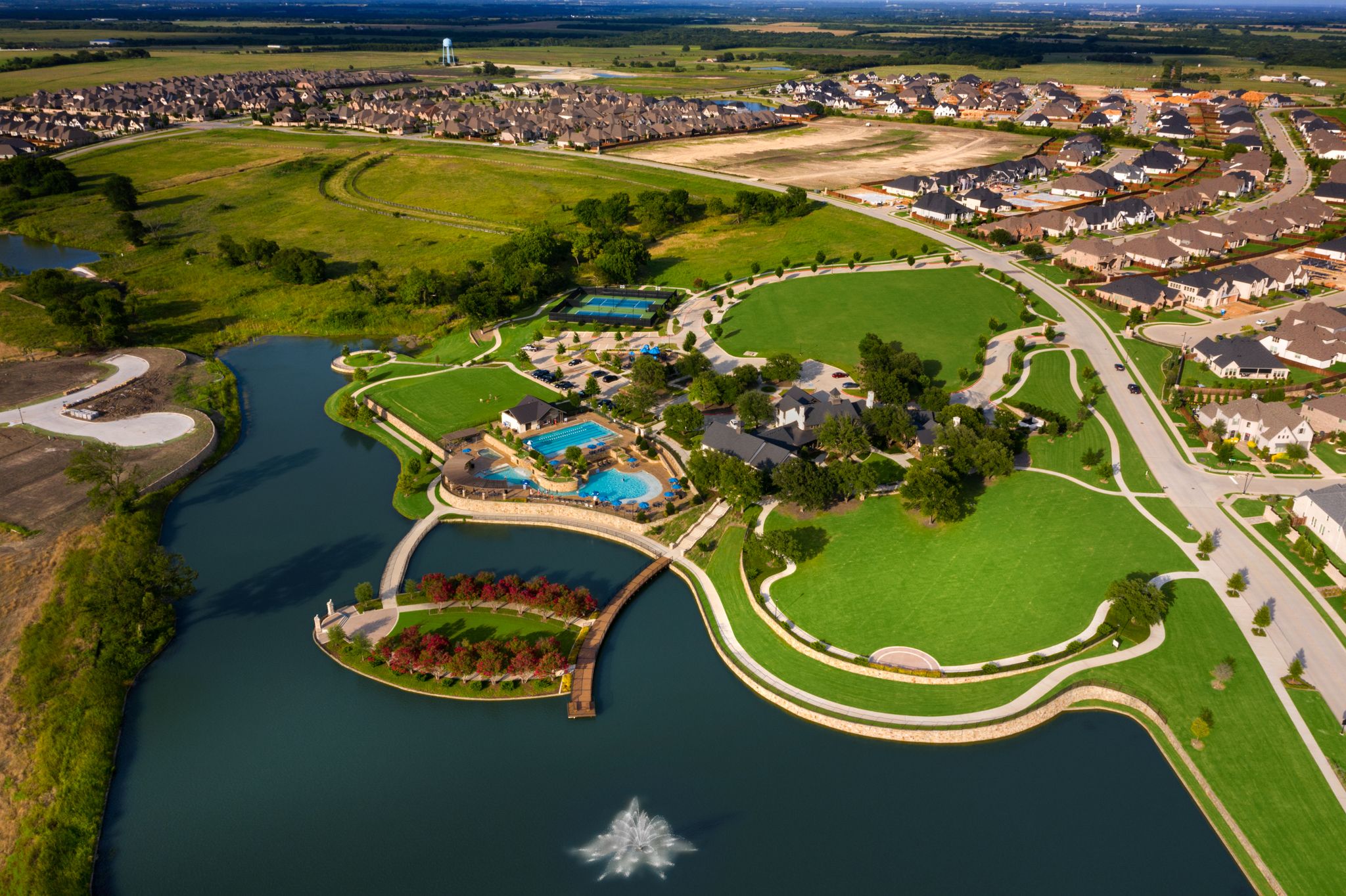 Mustang Lakes - Aerial of lake, pools, tennis courts, community