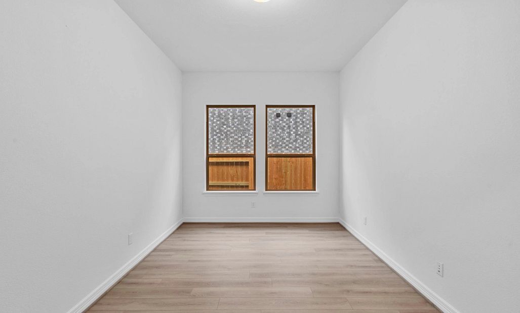 Private study with French doors, beautiful flooring, and large windows—perfect for work, creativity,
