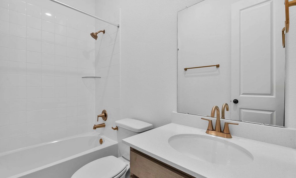 Modern third bath featuring the AW Collection Laguna with stained cabinetry, light countertops with