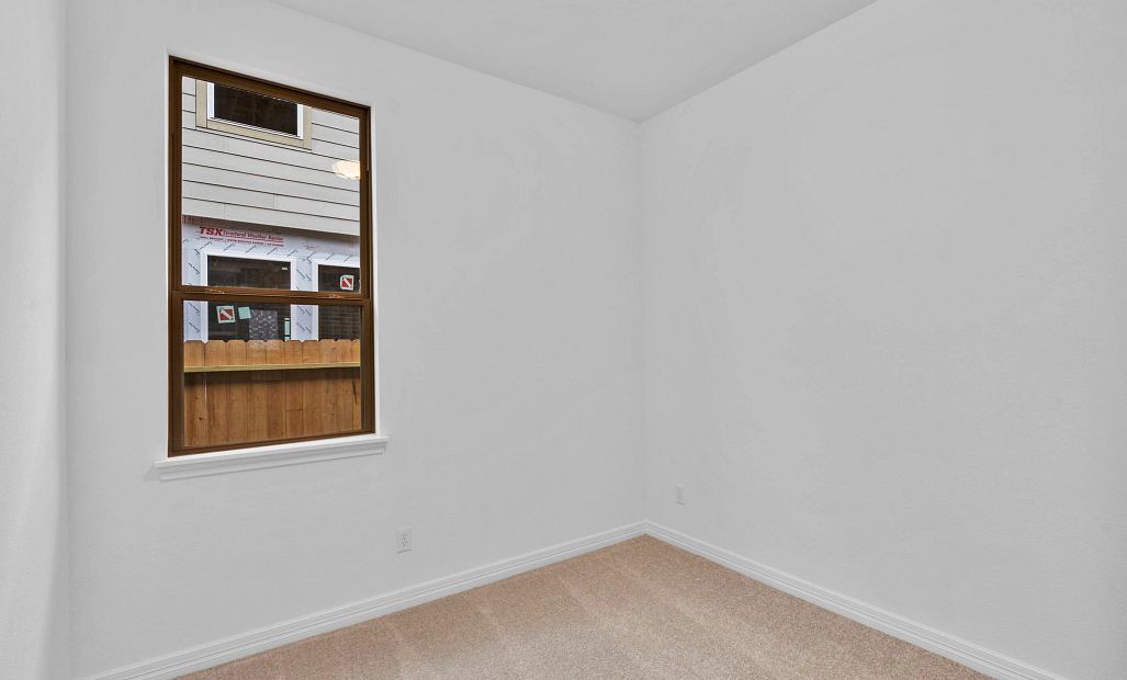 Perfect for family or guests—fourth bedroom with a walk-in closet and soft carpet underfoot.