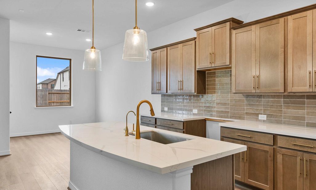Kitchen with abundant cabinetry, generous countertop space, a walk-in pantry, and a center island