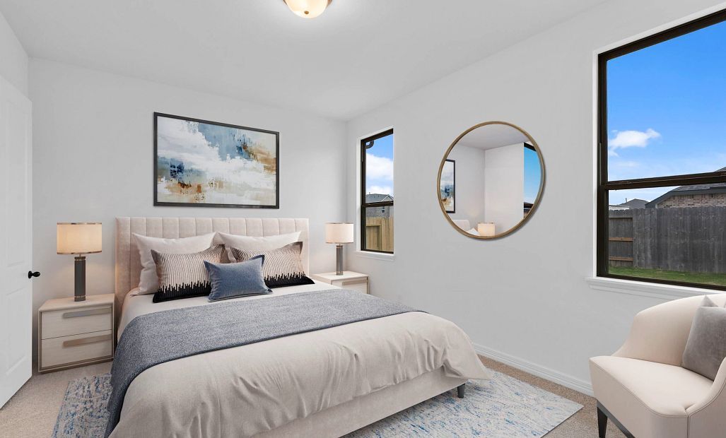 Luxurious primary suite with plush carpet, tray ceilings, and large windows—your perfect place to