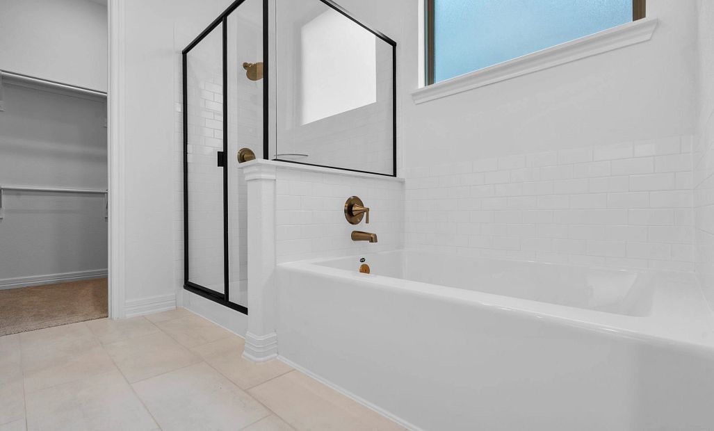A spa-like retreat featuring a walk-in shower and a deep soaking tub.