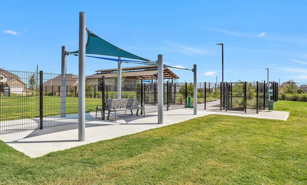 The dog park features spacious, fenced areas for both small and large dogs, as well as shaded