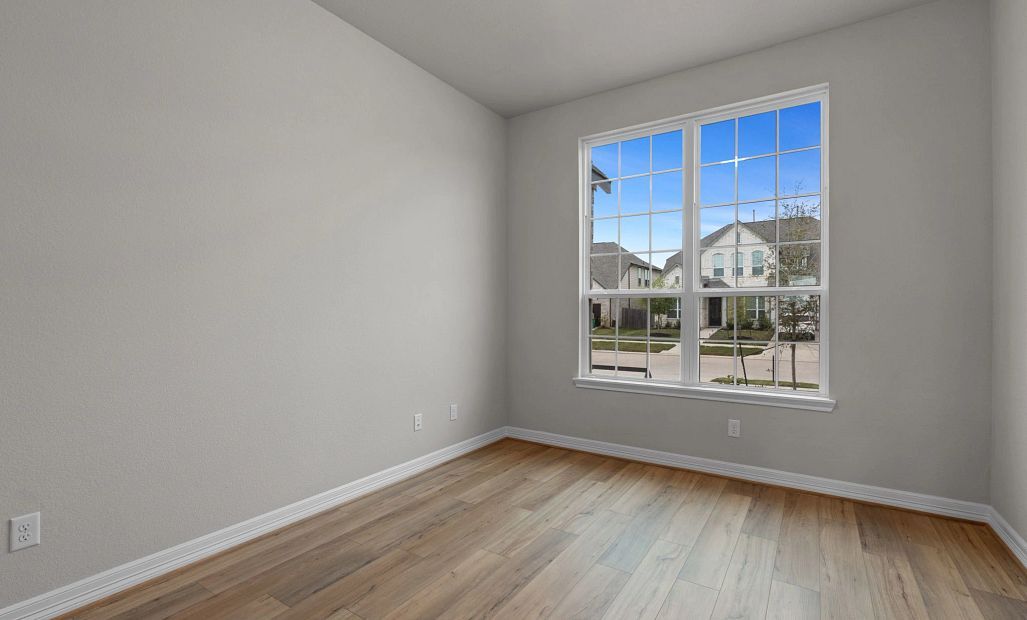 Private study at the front of the home featuring gorgeous flooring and large windows—perfect for