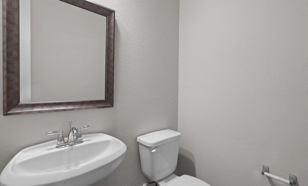 Convenient powder room located just off the living space for guests and everyday use.
