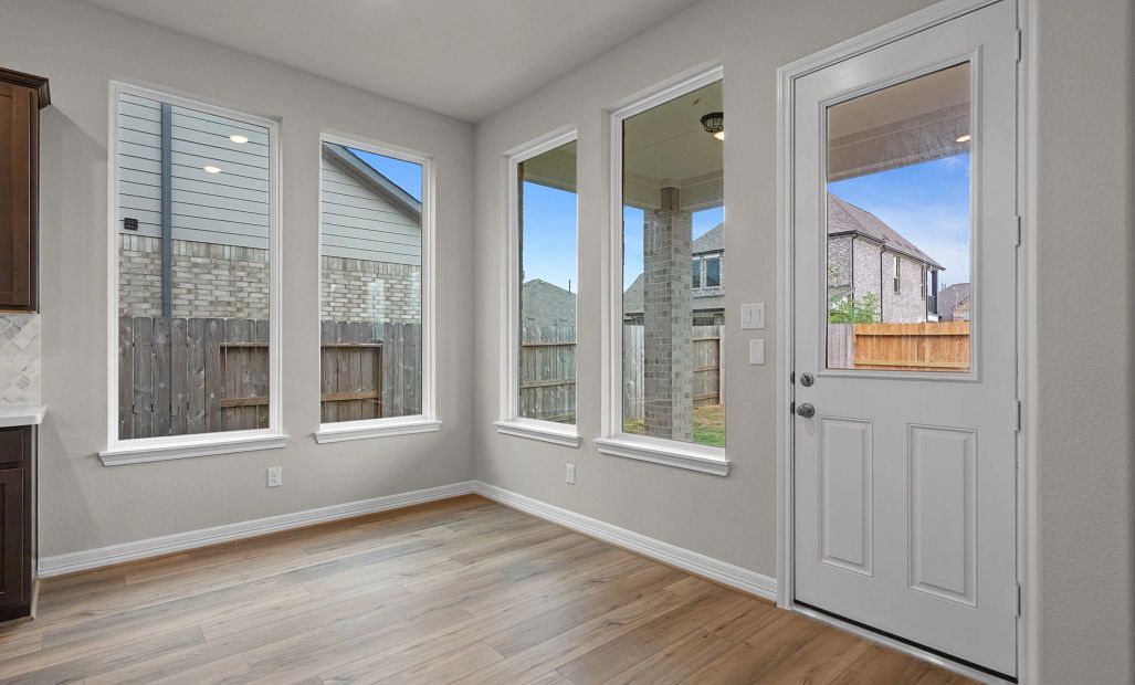 Sun-filled breakfast nook with large windows—perfect for morning coffee or casual family meals.