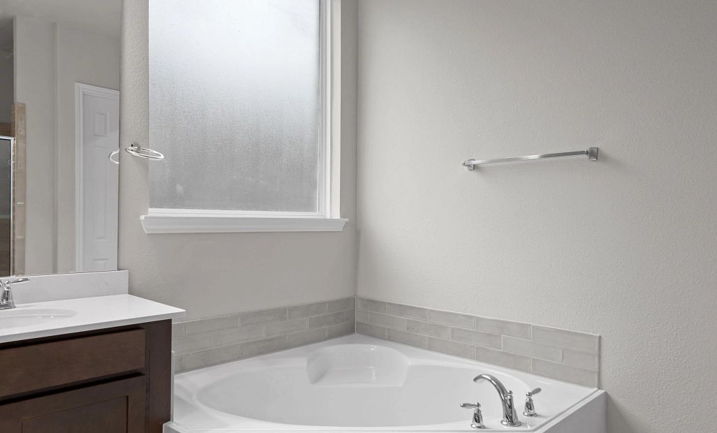 Luxurious primary bath with a large soaking tub—perfect for relaxing and unwinding after a long day.