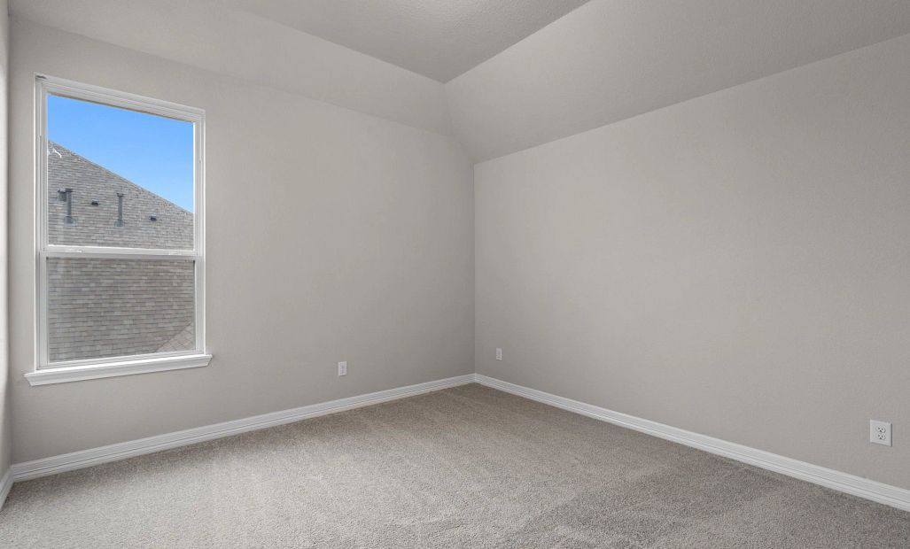 Second bedroom with walk-in closet, large window, and convenient access to the Jack and Jill