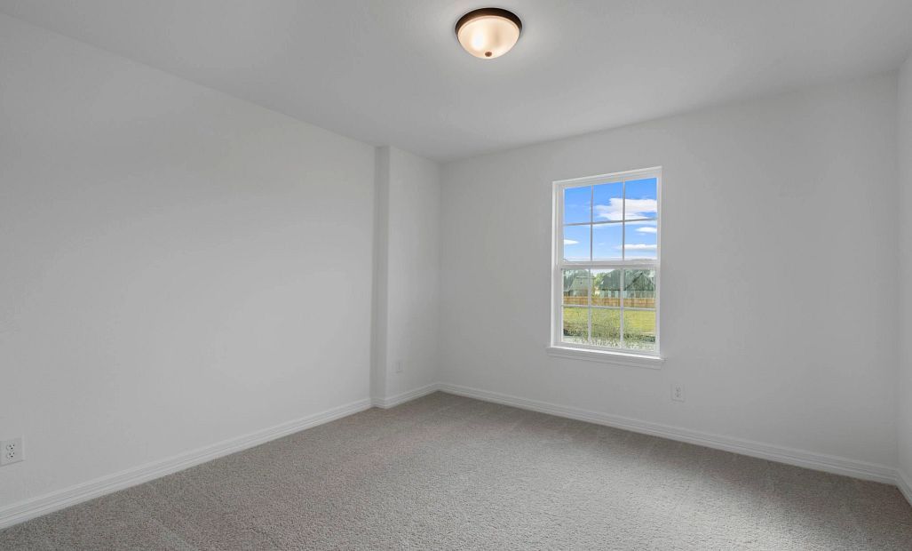 Second bedroom with private bath. Note: Sample product photo. Actual exterior and interior