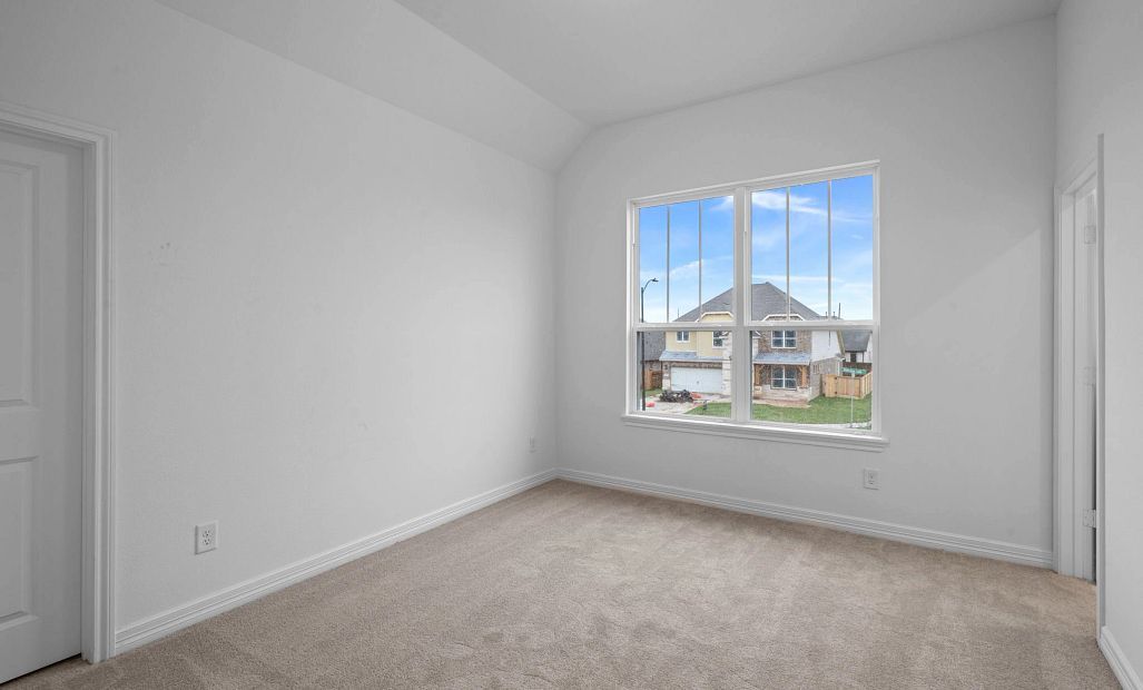 Second bedroom with private bath. Note: Sample product photo - actual exterior and interior