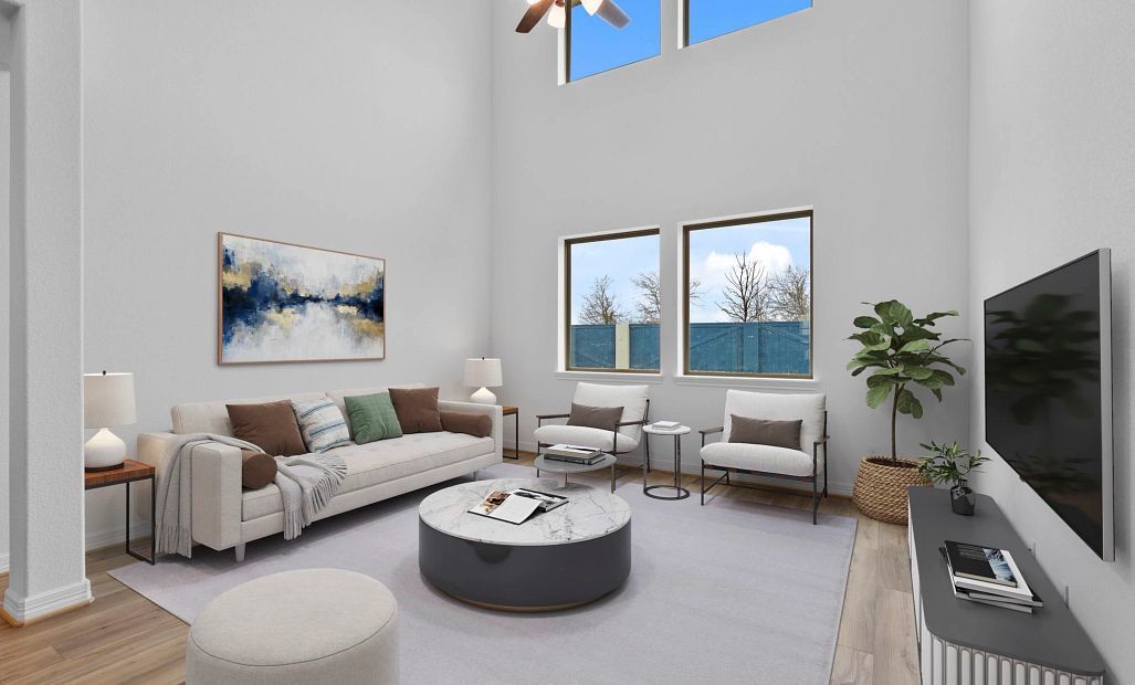 Bright and airy living room with soaring ceilings and large windows that create an open, inviting