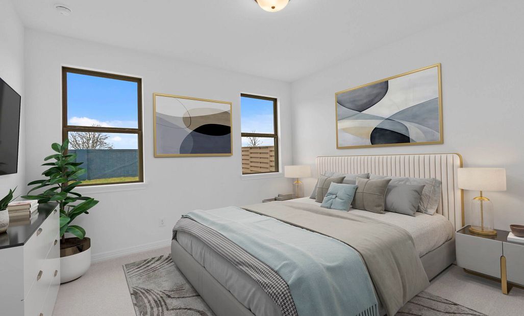 Spacious primary bedroom with natural light, private en suite, and a tranquil setting at the rear of