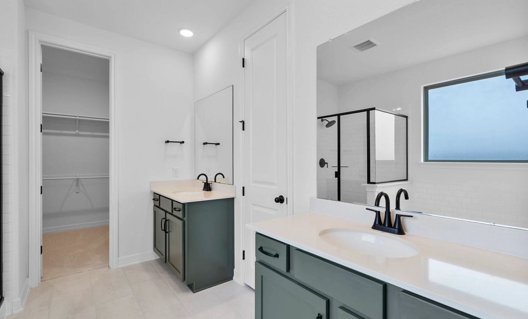 Primary bath featuring separate vanities from the AW Collection Rosemary, designed for comfort and