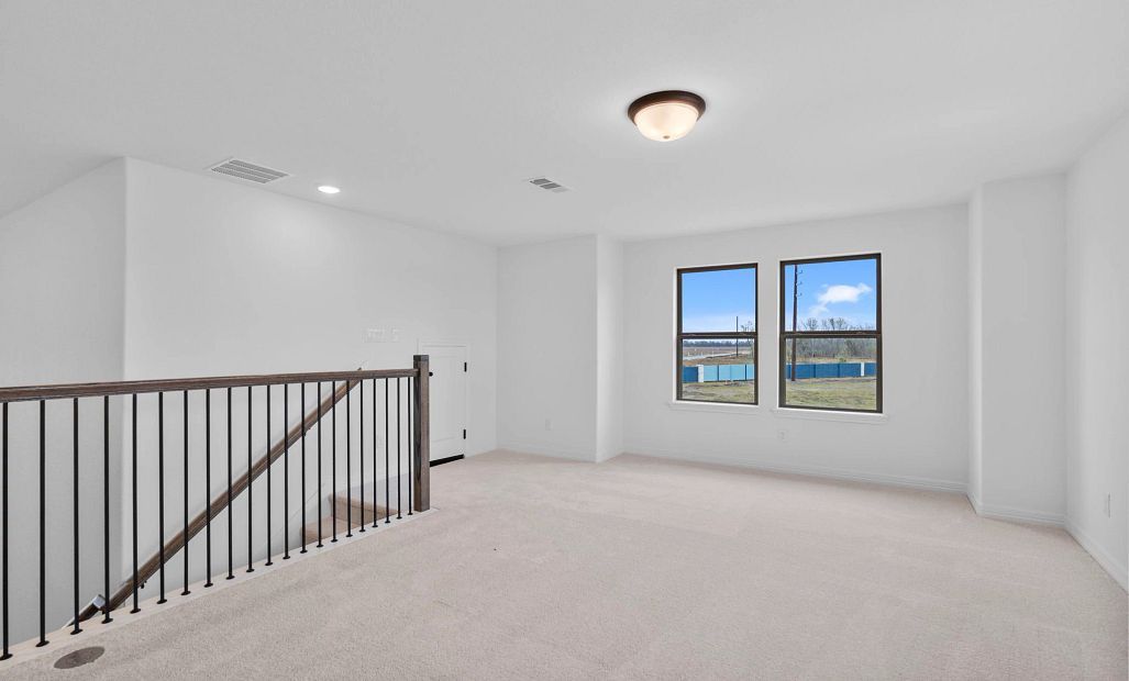 A bright, open game room upstairs designed for play, creativity, or relaxed lounging.
