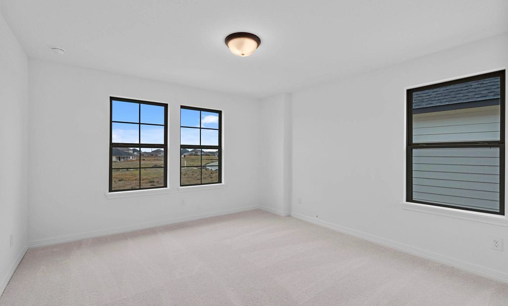 A generously sized secondary bedroom with ample natural light.