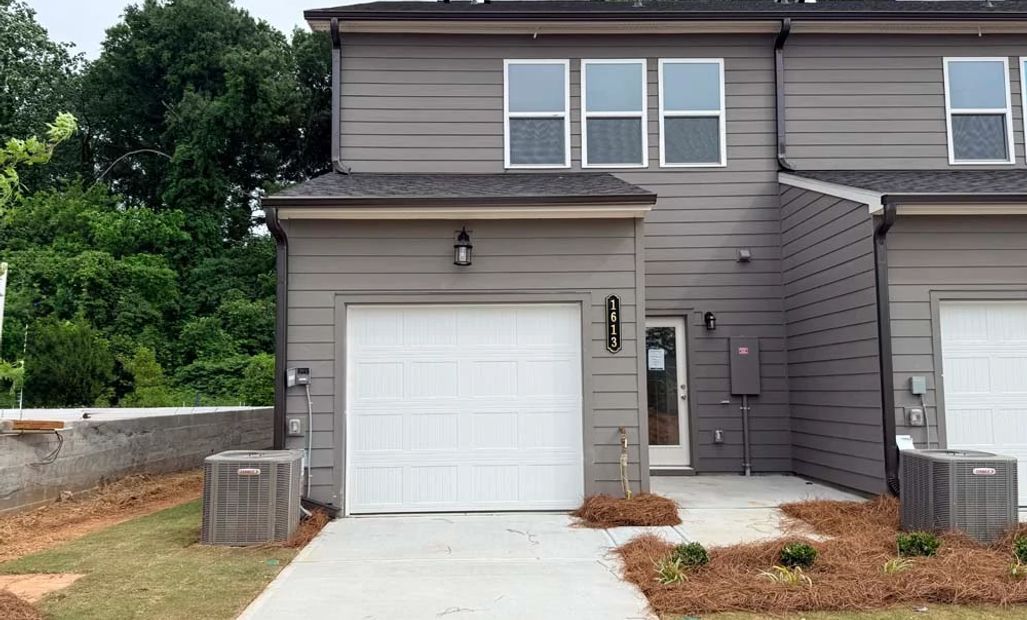 Sample Photo: Rear Exterior with One Car Garage