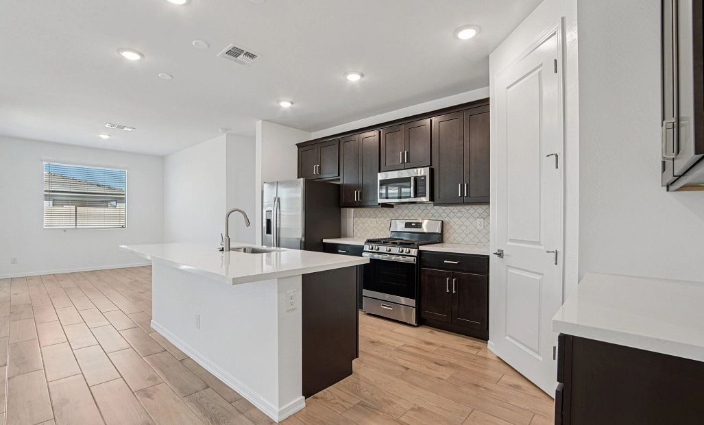 Kitchen and dining. Not actual home, finishes may vary by community.