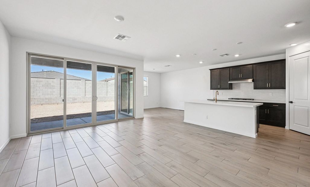 Great room, kitchen and dining. Not actual home, finishes may vary by community.