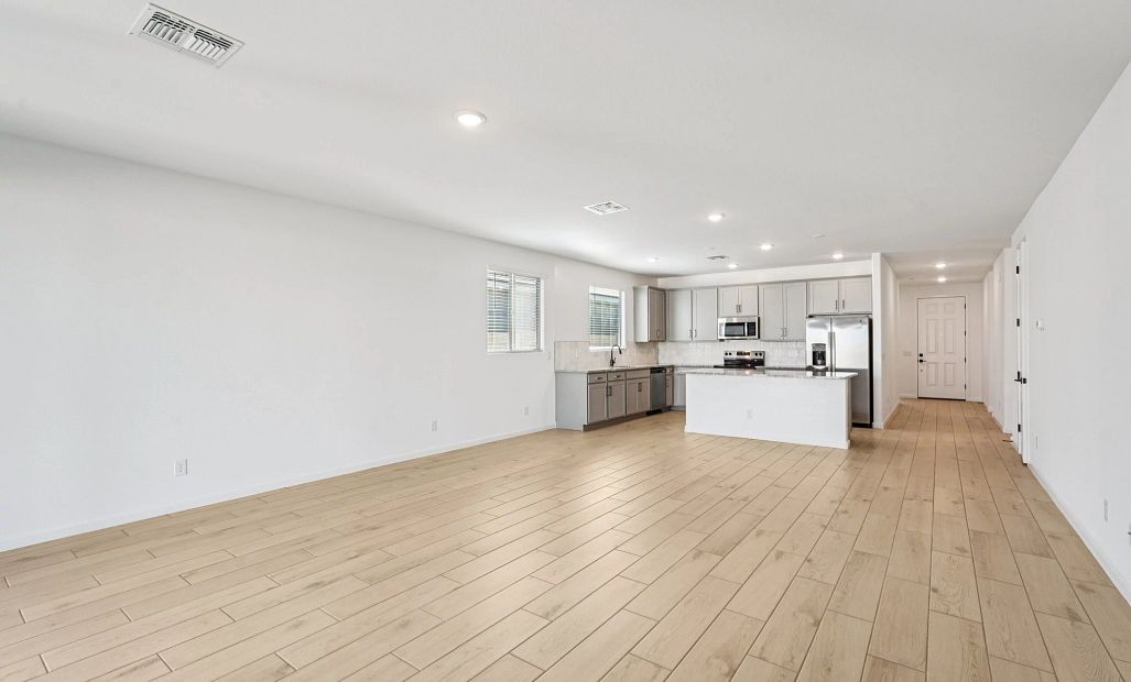 Great room and kitchen. Not actual home, finishes may vary by community.