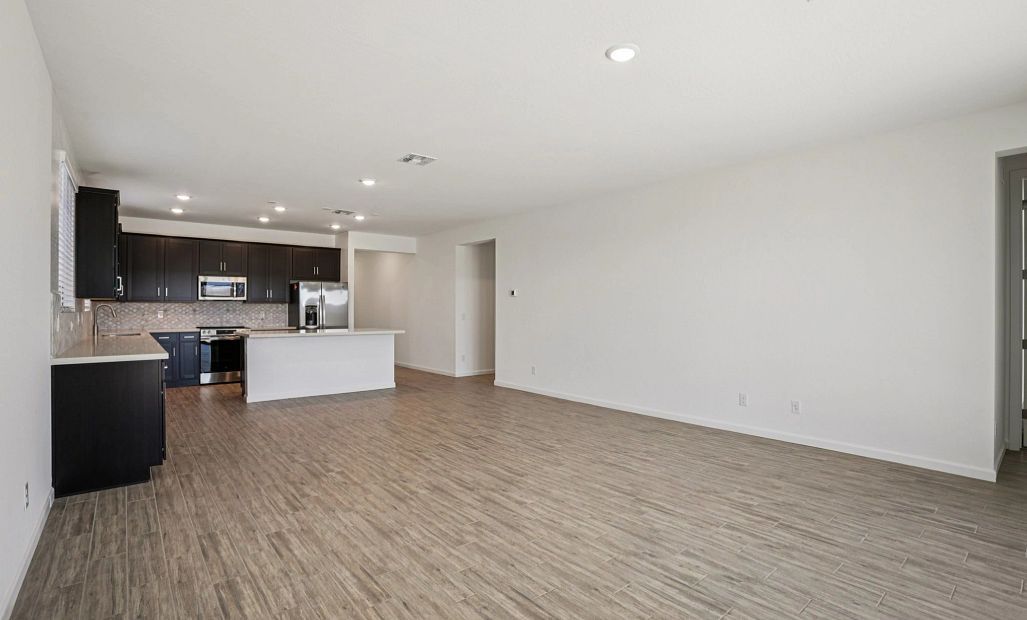 Great room and kitchen. Not actual home, finishes may vary by community.