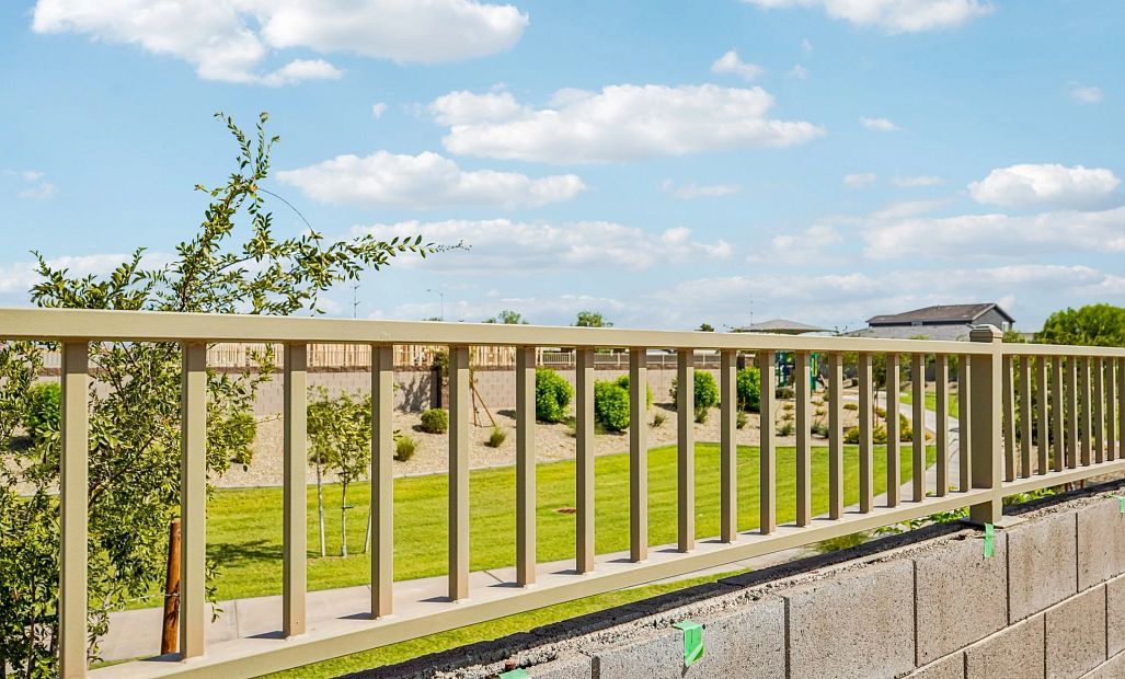 View fencing with green space and walking paths behind