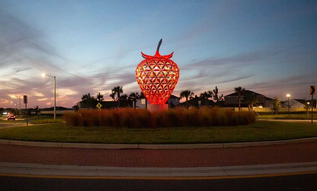 The beautiful berry monument in the community lit up at night