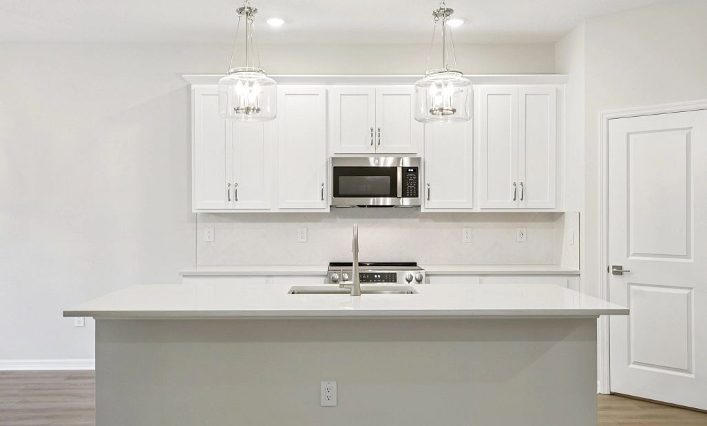 Spacious kitchen with large island featuring AW Collection® Timeless