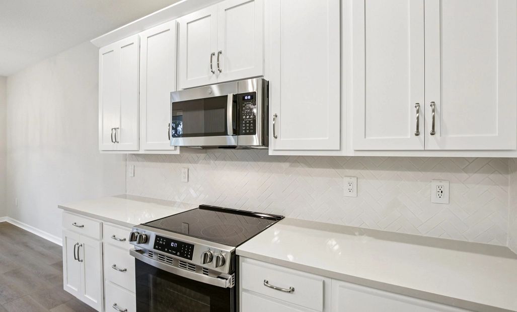 Kitchen features stainless steel appliances and a beautiful herringbone backsplash from our AW