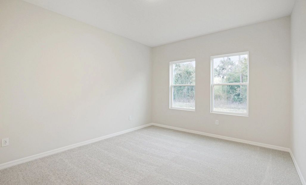 Large primary bedroom with double windows