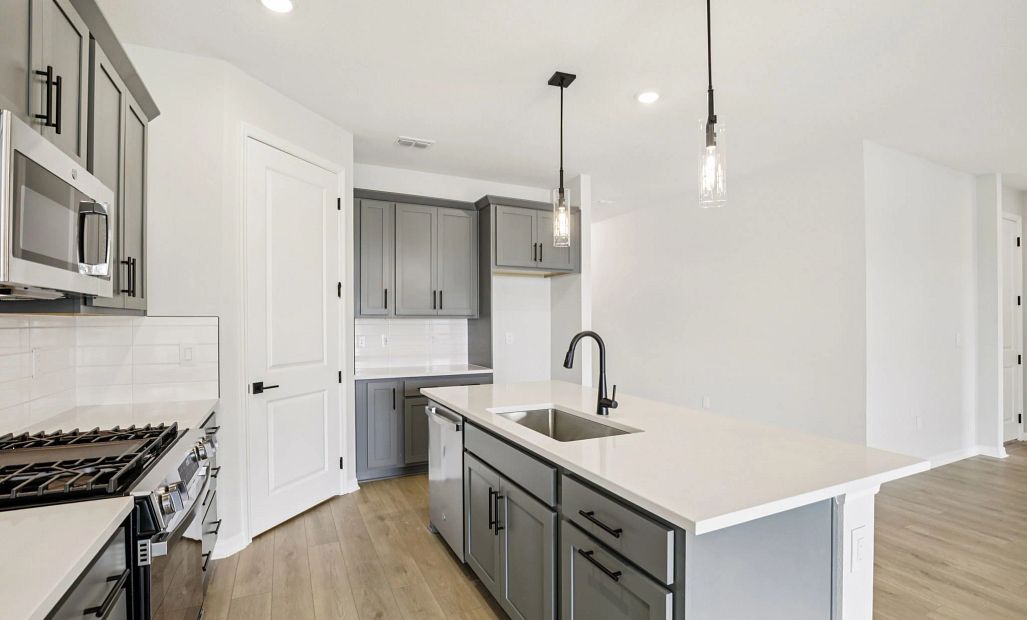 Large island and plenty of cabinet space in the kitchen featuring AW Collection® Minimalist