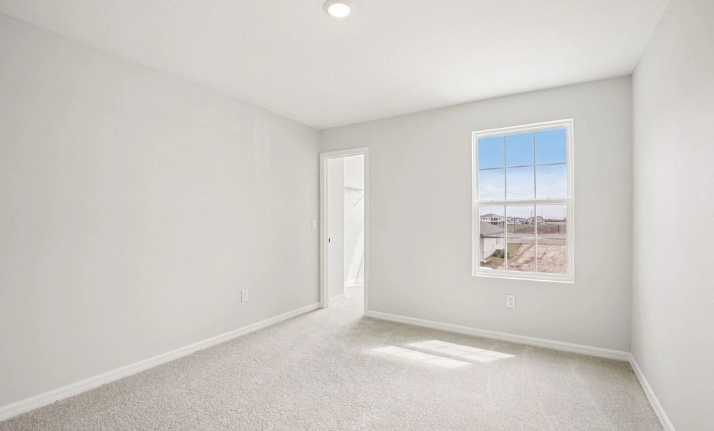 Bright bedroom 3 featuring a large walk-in closet