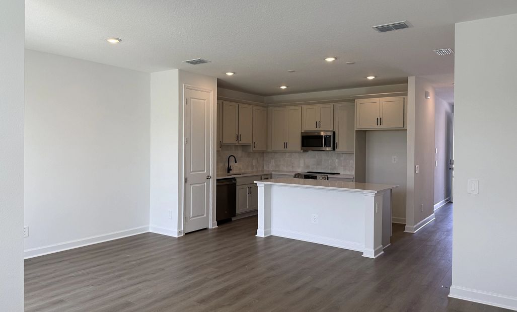 Open concept plan allows for a seamless transition between kitchen, dining and living spaces