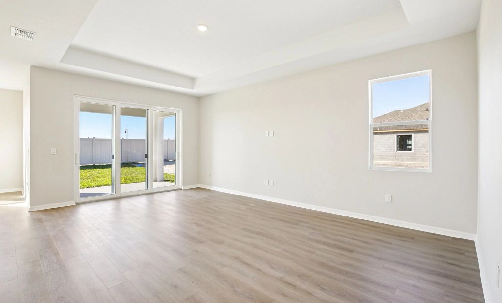 Family room featuring a tray ceiling and a large sliding glass door
