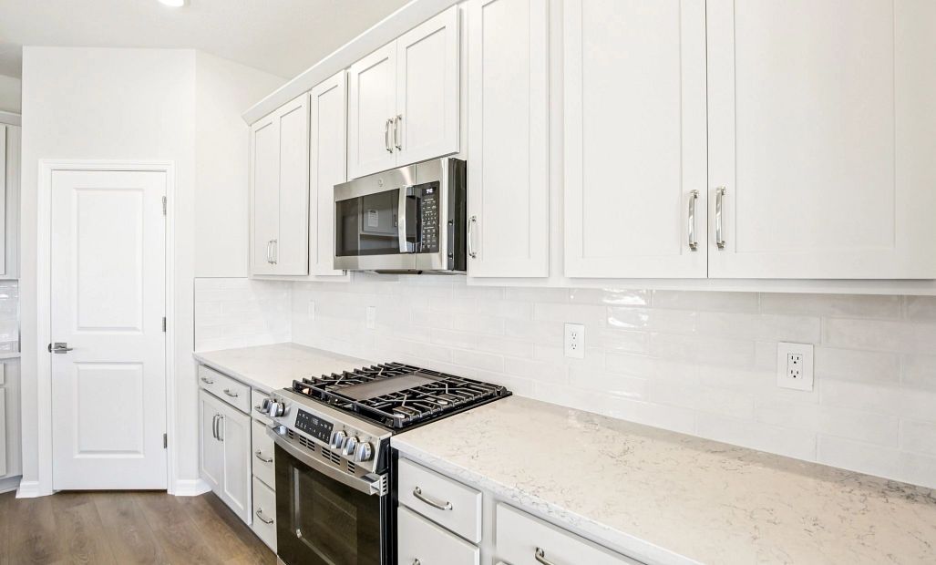 Gas stove and plenty of cabinets and drawers throughout