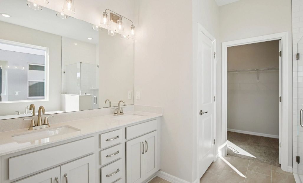 Beautiful primary bathroom featuring double sinks and aspects of AW Collection® Milan