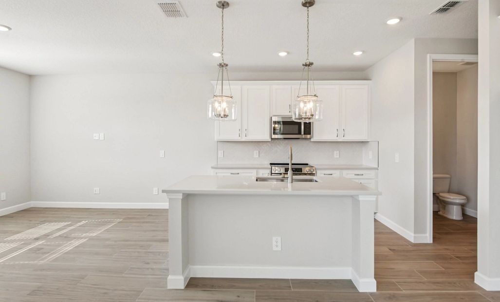 Large island centers the beautiful AW Collection® Timeless kitchen