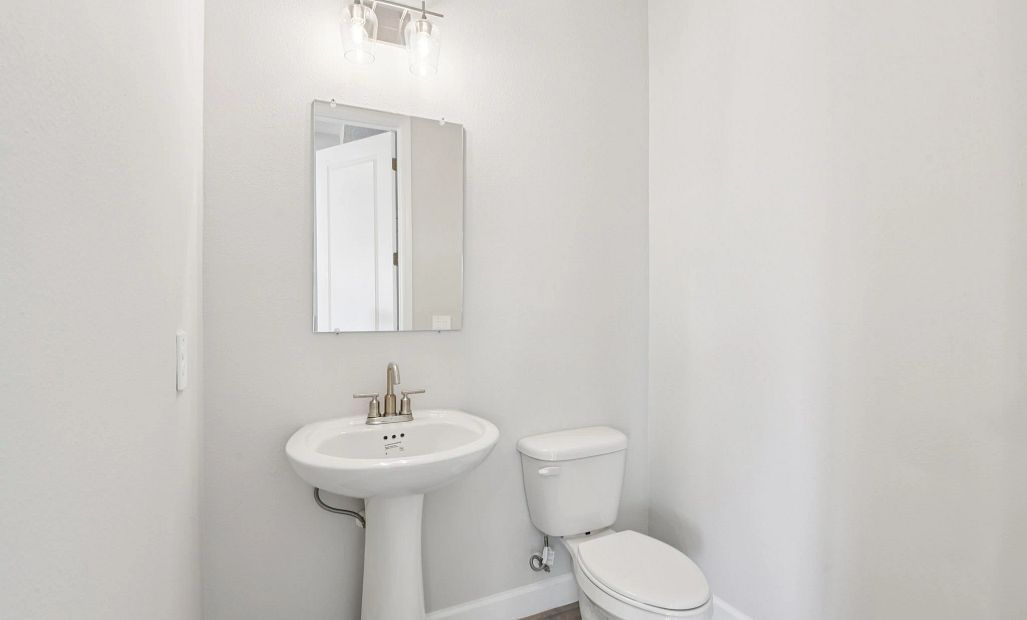 Half bathroom located off the kitchen near the garage