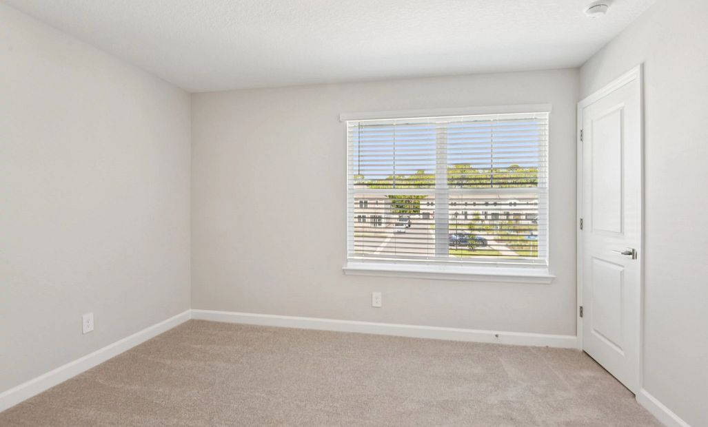 Bedroom 3 located at the front of the home and features a double window