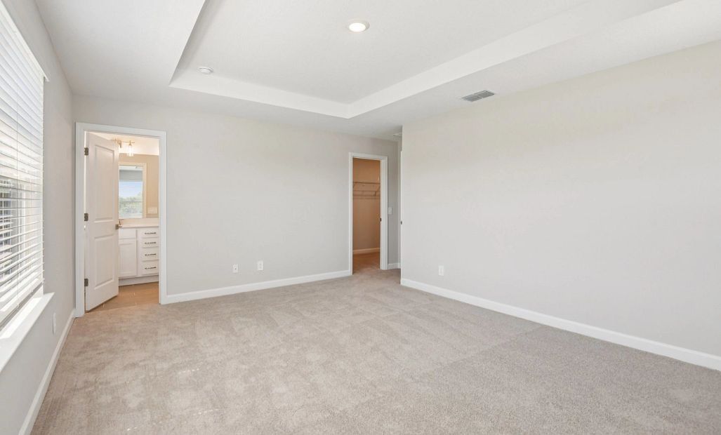 Primary bedroom features a walk-in closet separate from the primary bathroom