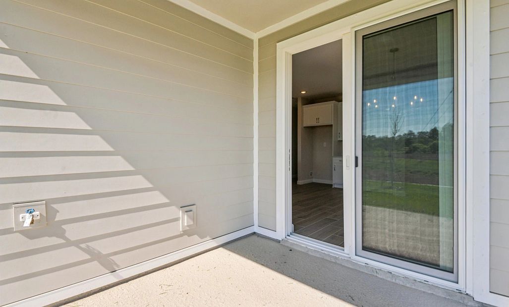 Covered back lanai with large sliding glass doors