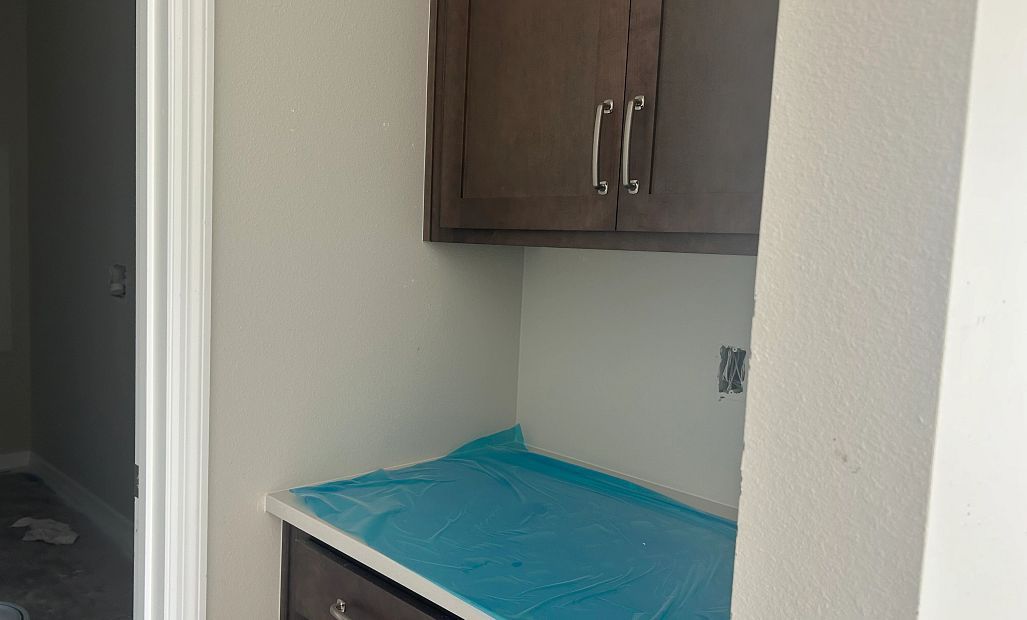 Valet cabinets located off the garage making the perfect drop zone and storage - under construction