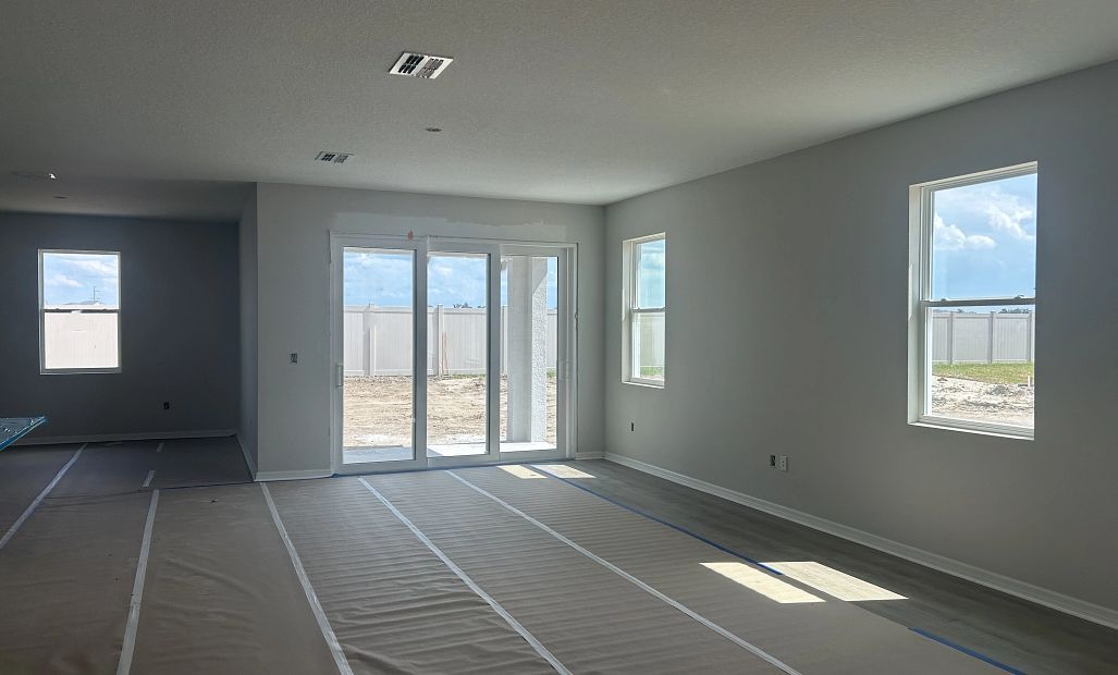 As you continue down the foyer you walk into the open dining and family room space - under